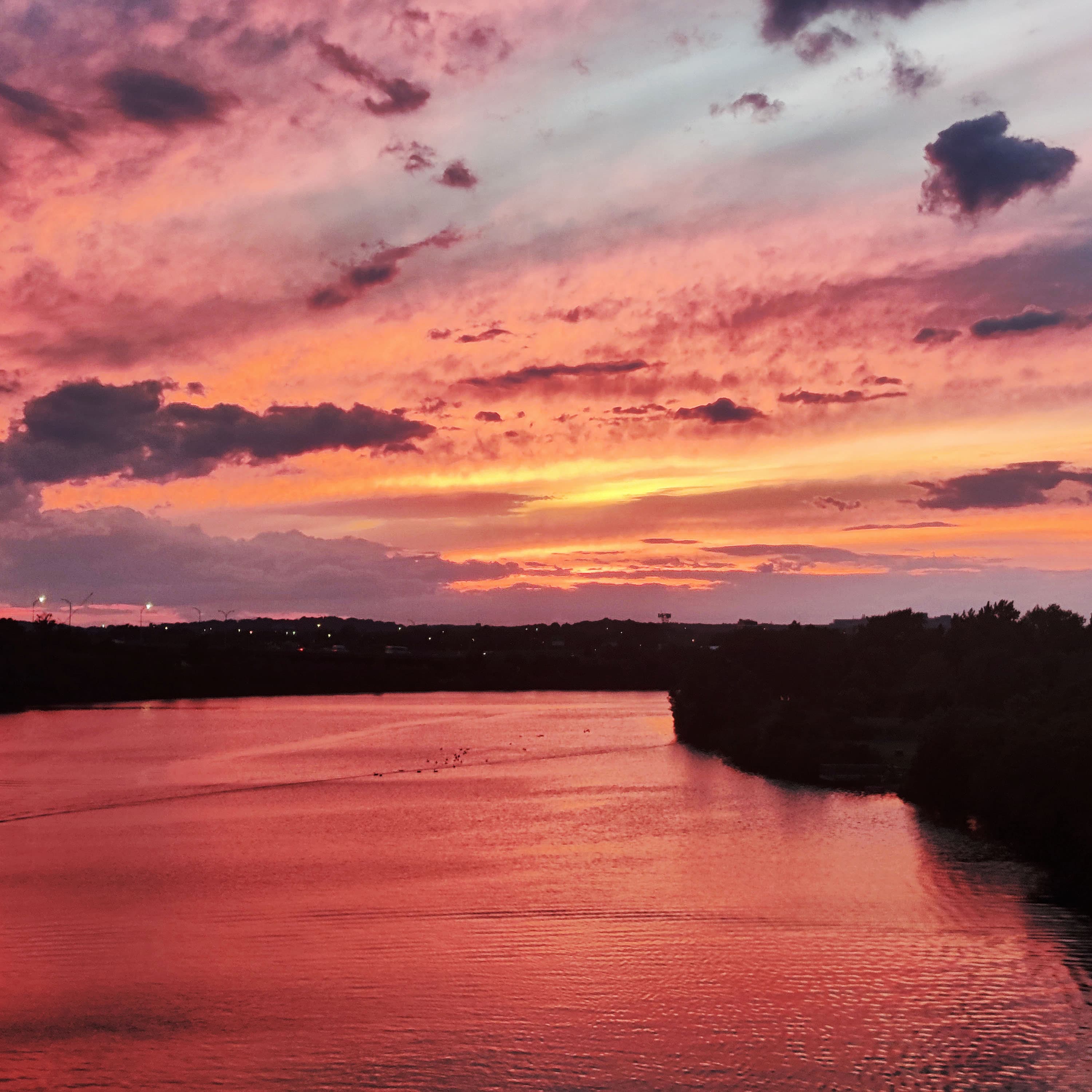 a bright orange sky after sunset, taken from the BU bridge looking over the charles