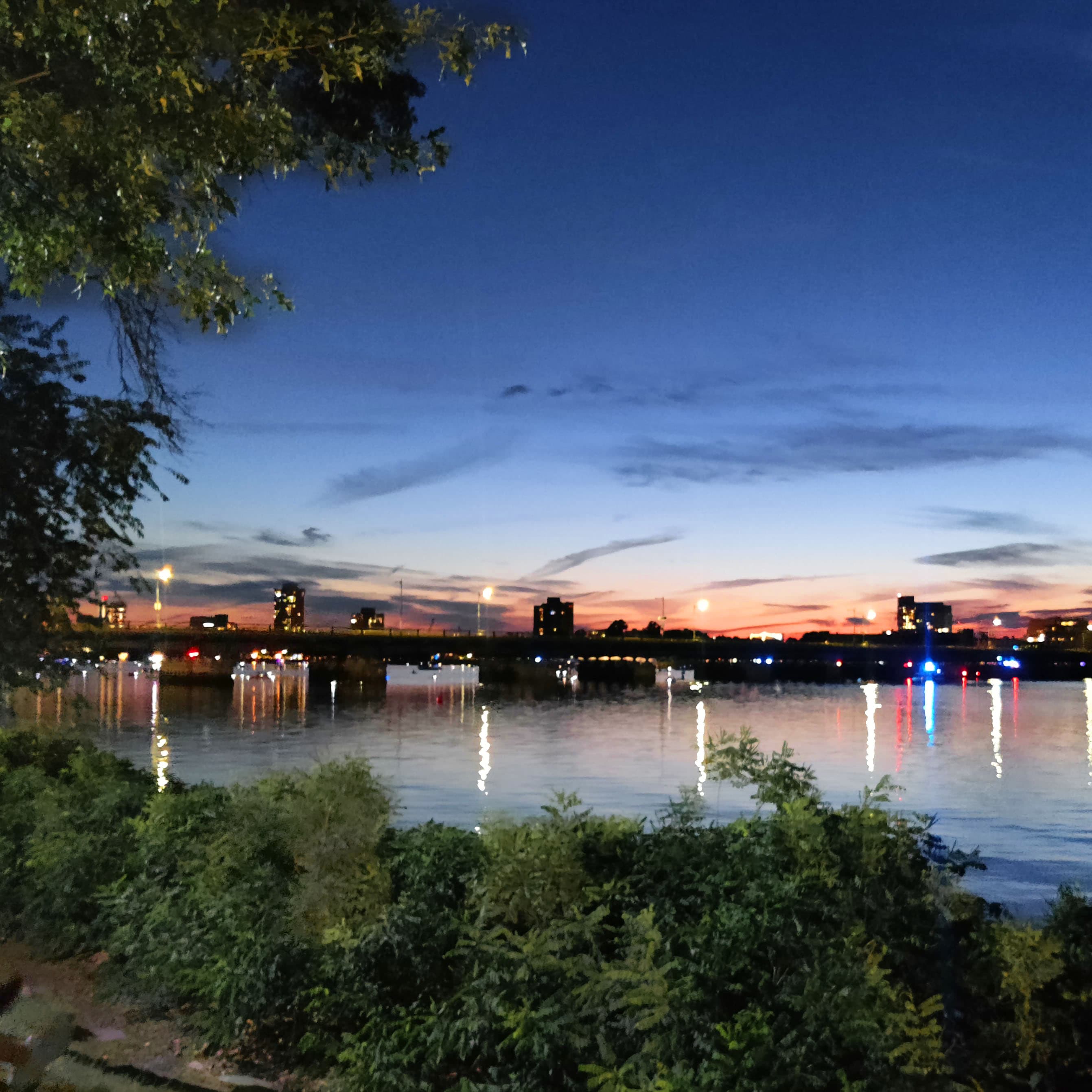 harvard bridge, in front of an orange and blue sky