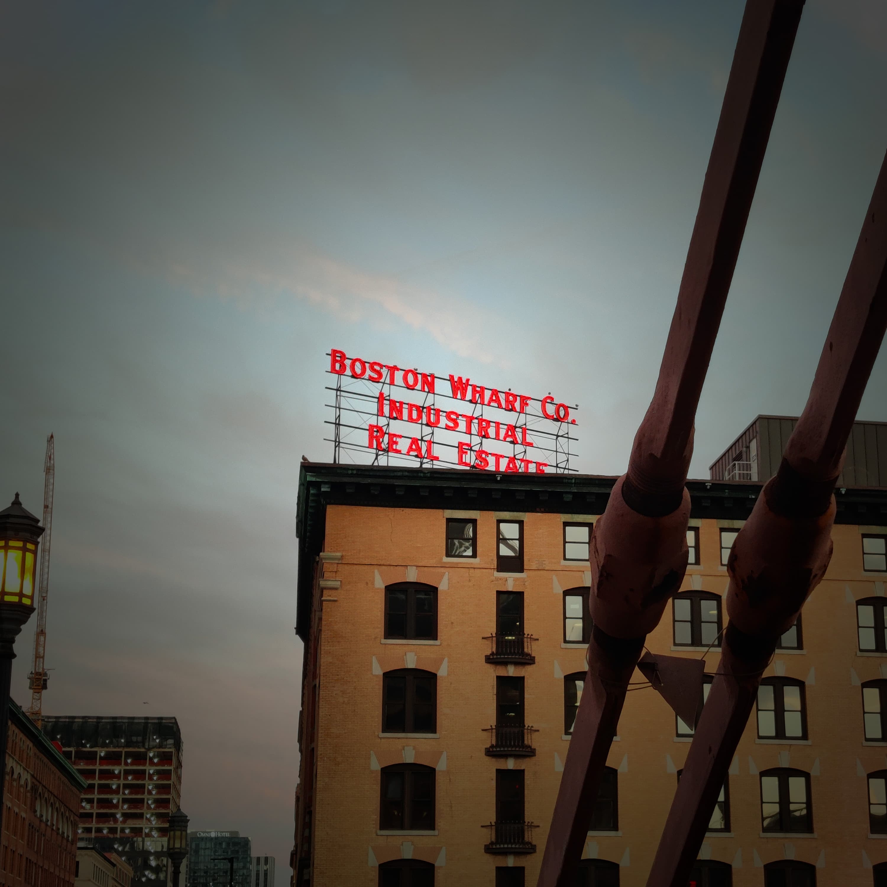 seaport's "boston wharf co" sign as viewed from a bridge